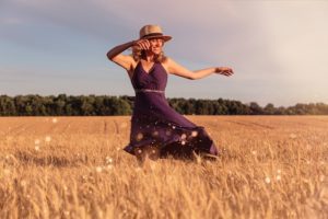 Woman in field dancing 